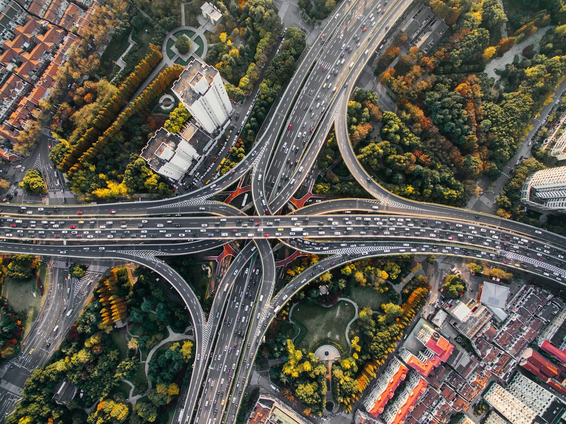 Aerial view of a sweeping highway interchange surrounded by greenery